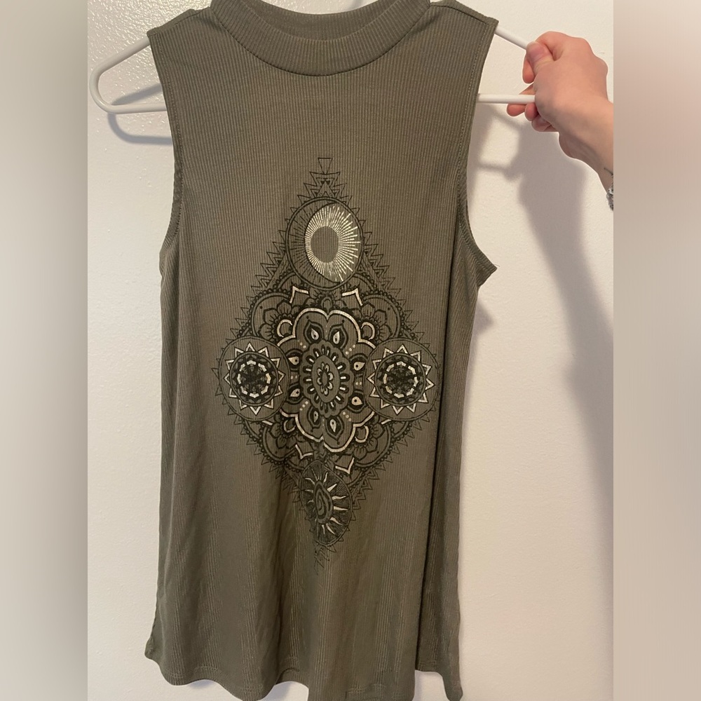 Maurice’s dark green high neck shirt with mandala design